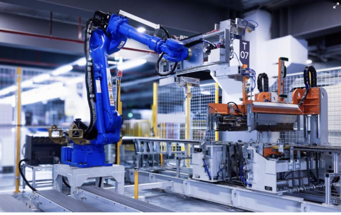 An industrial robot arm on an automated production and packing line